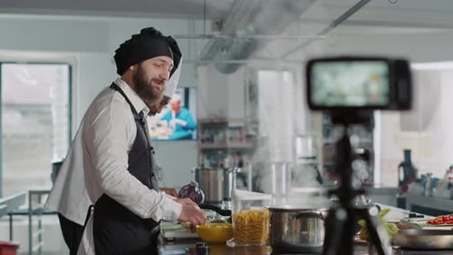 Chef Giving Cooking Tutorial in Bright Commercial Kitchen