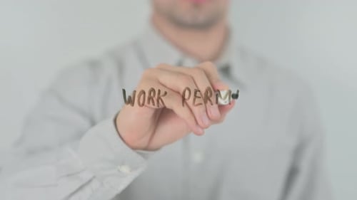 Man Writes Work Permit on Glass Surface