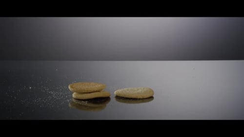 Delicious Cookies Falling on Reflective Surface in Slow Motion
