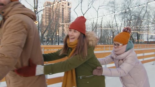 Family Enjoying Time On Ice Rink