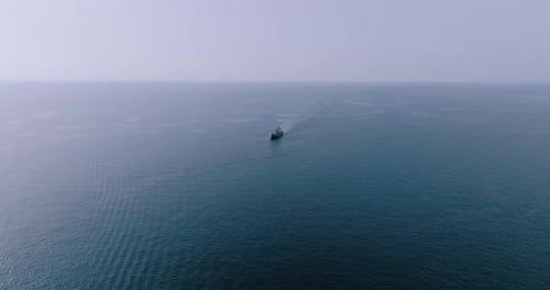 Aerial View of a Boat That Moves on the Deep Blue Sea