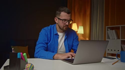 Man Reacts to Laptop While Working from Home