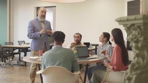 Team Having Casual Lunch Meeting in Modern Office