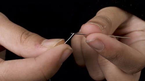 Trying to Thread a needle using both hands