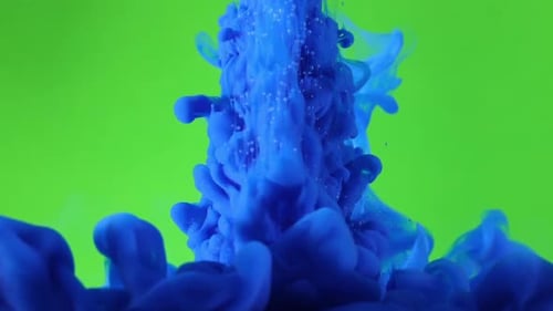 Blue ink sprayed in front of green screen