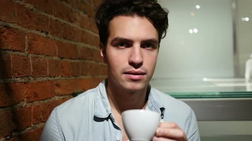 Young Adult Man Drinking Coffee Indoors