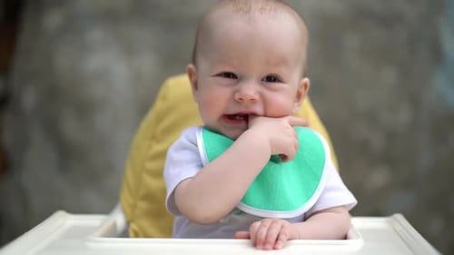 Happy Baby Sitting in High Chair Smiling