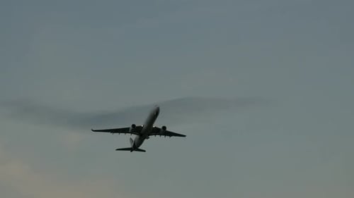 Airplane Flying Upward into the Grayish Sky