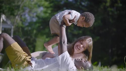 A Multicultural Family Lies in the Park