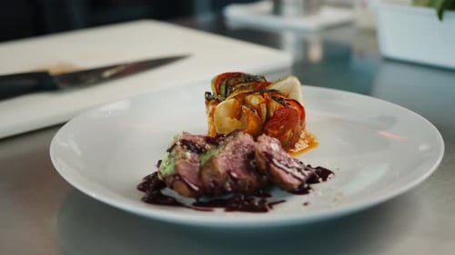 Filet mignon and ratatouille on a plate serving a dish in a restaurant