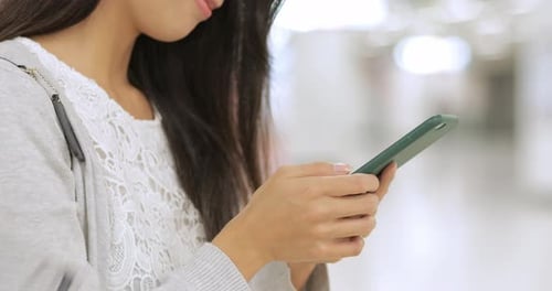Woman using cellphone in the station