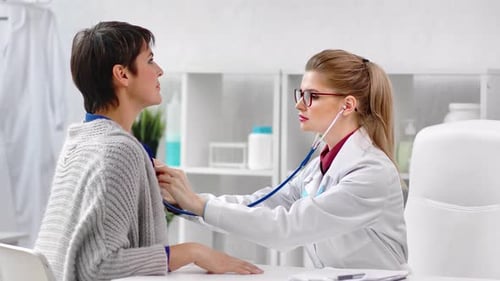 Doctor Listening to Patient's Heart With Stethoscope