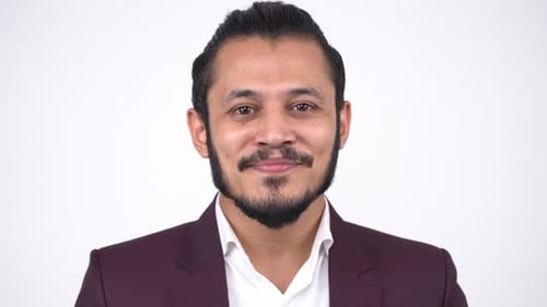 Man Smiling at Camera in Front of White Background