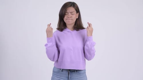 Woman Crosses Fingers and Prays for Good Luck