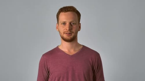 Smiling Man Raises Clenched Fist in Success