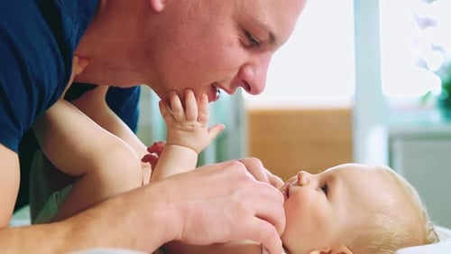 Father and Infant Interact Affectionately Indoors