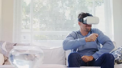 Man Wearing VR Headset Enjoying Himself on Couch