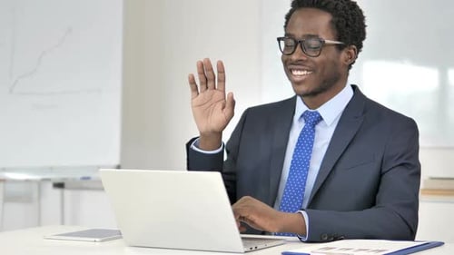 Young Adult Business Professional Video Conferencing on Laptop