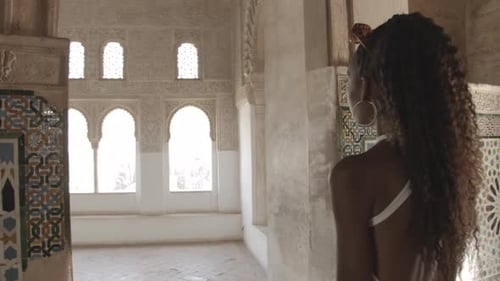 Woman Exploring Ornate Historical Palace Interior