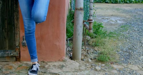Stylish Woman with Phone Leaning Against a Wall