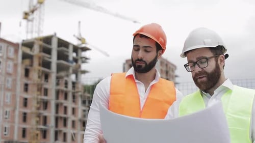 Male Construction Engineer Discussion with Architect at Construction Site or Building Site of