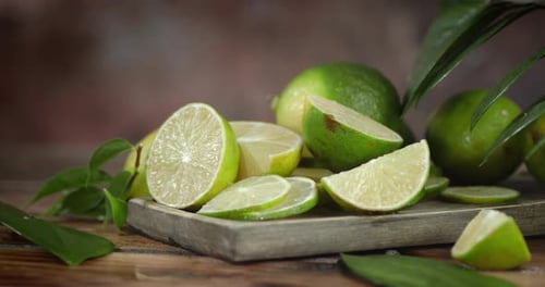 Close Up Of Sliced Limes on Wooden Surface