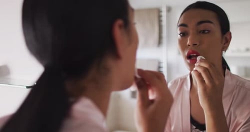 Young Adult Applying Make-up at Home