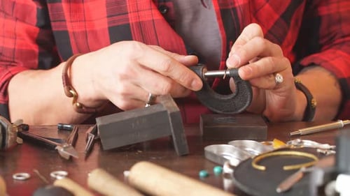 Young Man Concentrated on Cleaning Tool in Workshop
