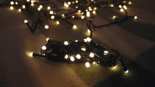 Closeup Shot Hank of Christmas Garland with Golden Lights on a Playd