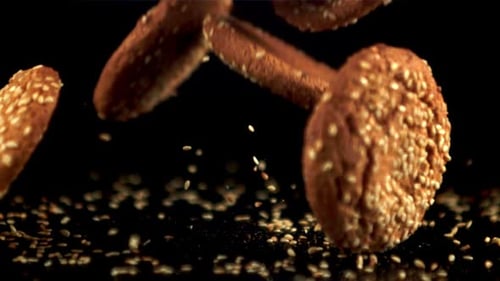 Super Slow Motion Fresh Oatmeal Cookies with Sesame Seeds Falls on the Table