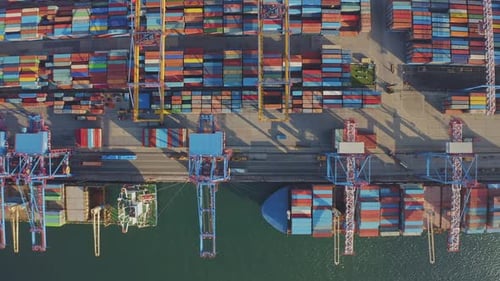 Loading and Unloading a Container Ship in the Port at the Pier