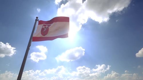 Realistic Waving Flag with Coat of Arms in Blue Sky