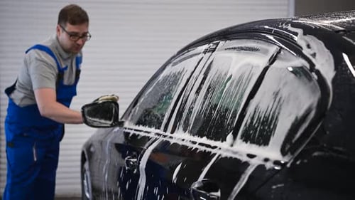 Man Washing Car With Soap And Sponge
