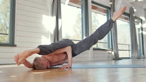 Man Doing Yoga in Bright Home Studio