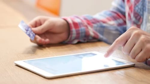 Hands using Tablet and Credit Card