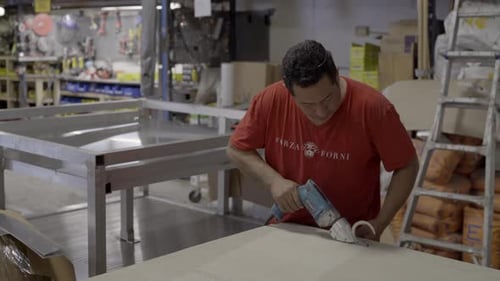 Worker cuts board for project