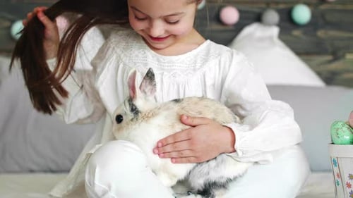 Adorable Girl Gently Petting a Bunny Rabbit