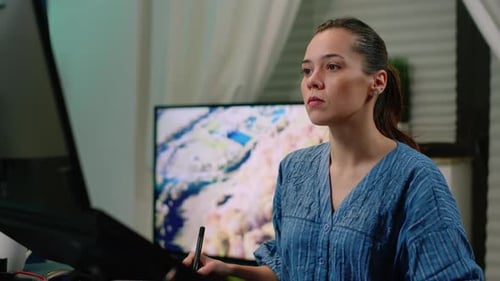 Young Woman Using Stylus On Digital Tablet