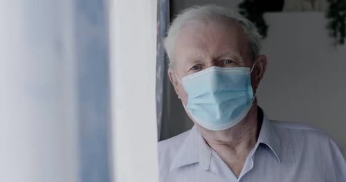 Senior Man Wearing Protective Surgical Mask