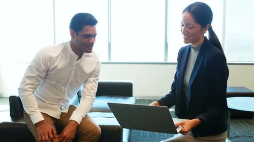 Business Professionals Discuss Ideas in Modern Office