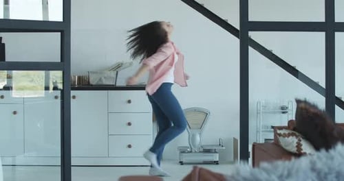 Young Woman Dancing Freely at Home