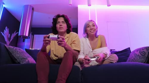 Couple Playing Video Games at Home at Night
