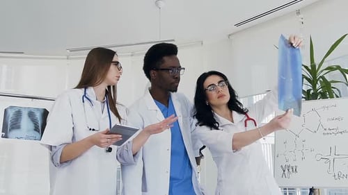 Doctors Analyze X-Ray in Modern Medical Office