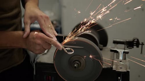 Craftsman Sharpening Scissors on a Grinding Wheel