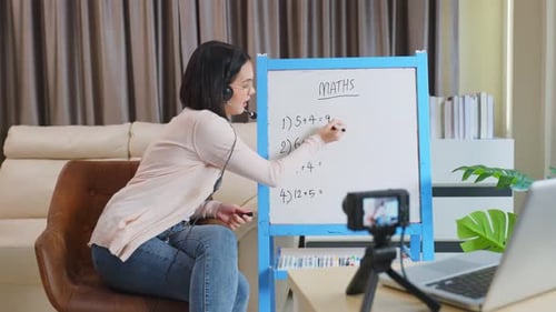 Asian school young woman teacher working from home teach online math subject to student at home.