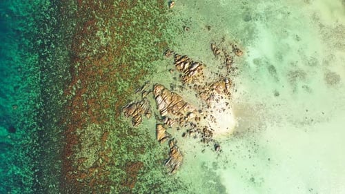 Sea texture with beautiful cliffs naturally caved by clear water of turquoise lagoon with coral reef