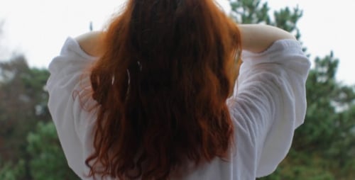 Young Redhead Girl on Balcony