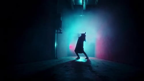 Silhouette Dancer in Smoky Urban Environment