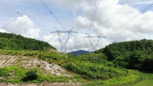 Electricity Pylons in Green, Hilly Rural Landscape