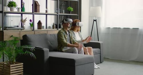 Couple Enjoying Virtual Reality Experience at Home